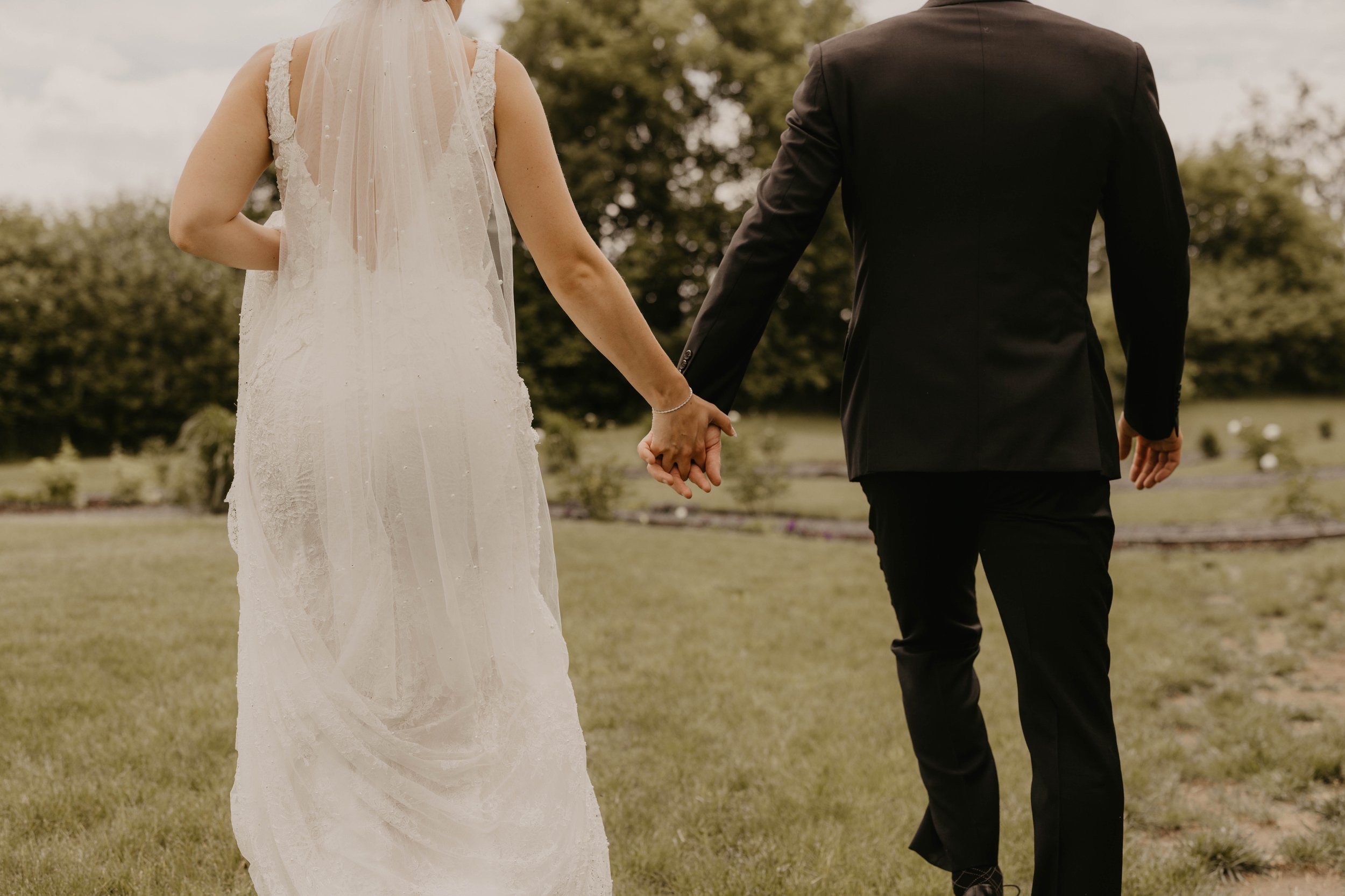 bride and groom holding hands