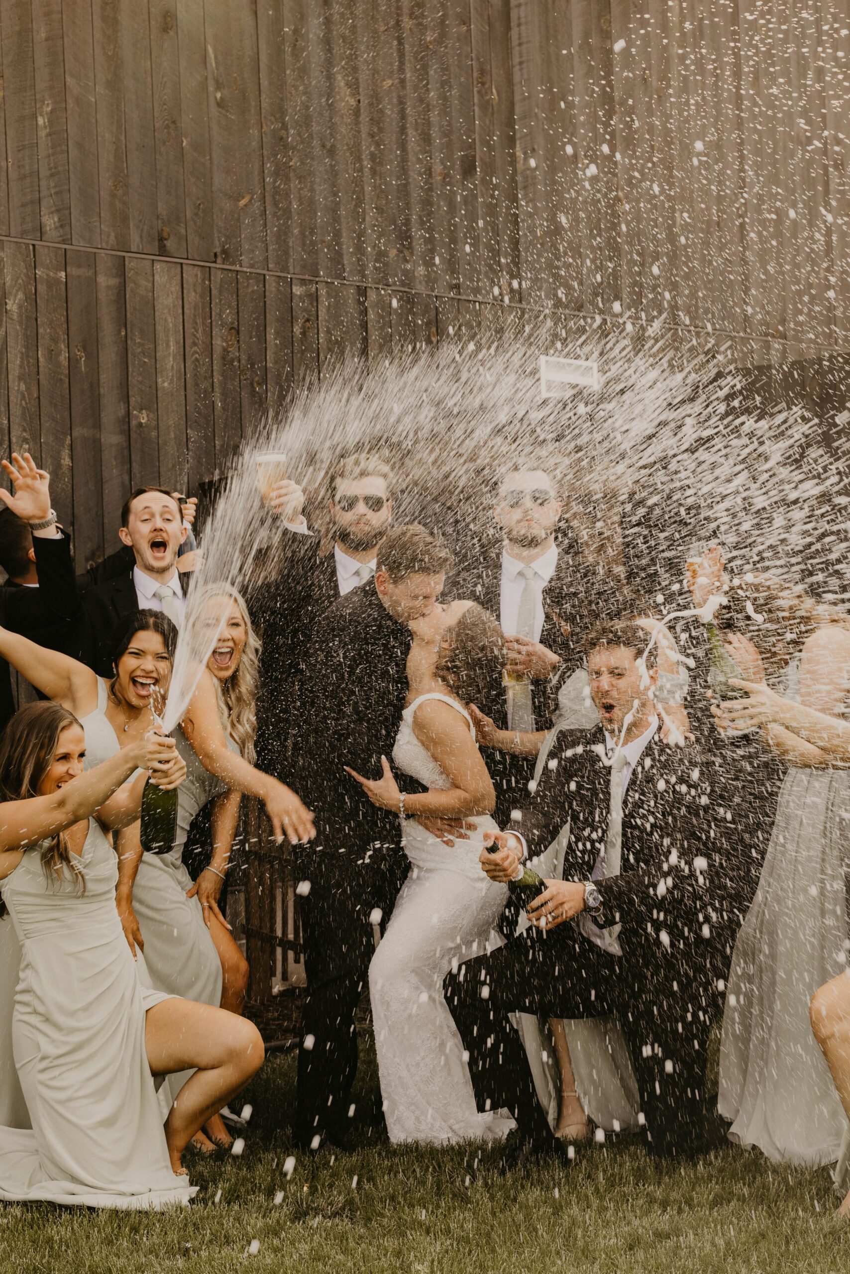 Bridal Party Popping Champagne