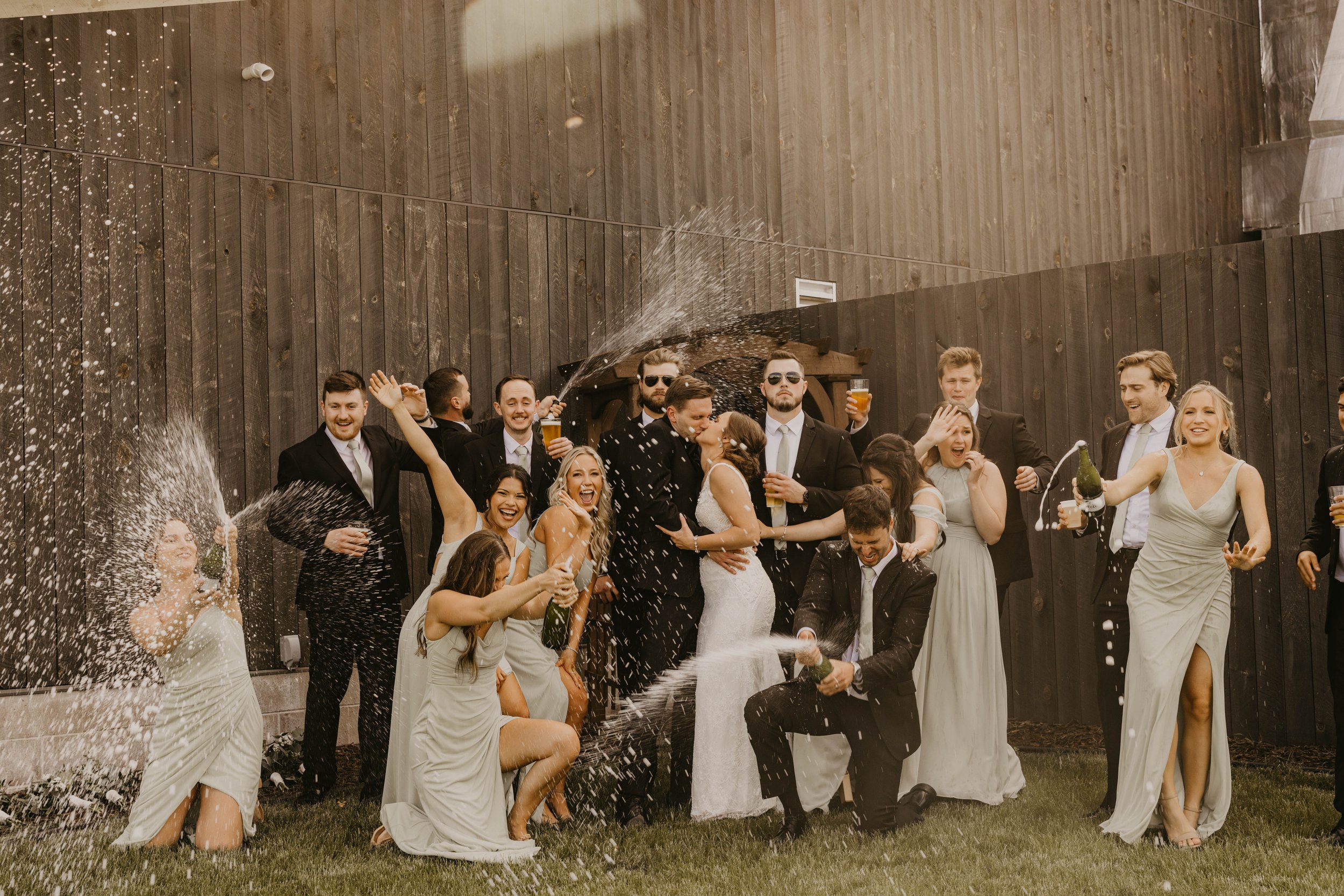 Bridal Party popping champagne