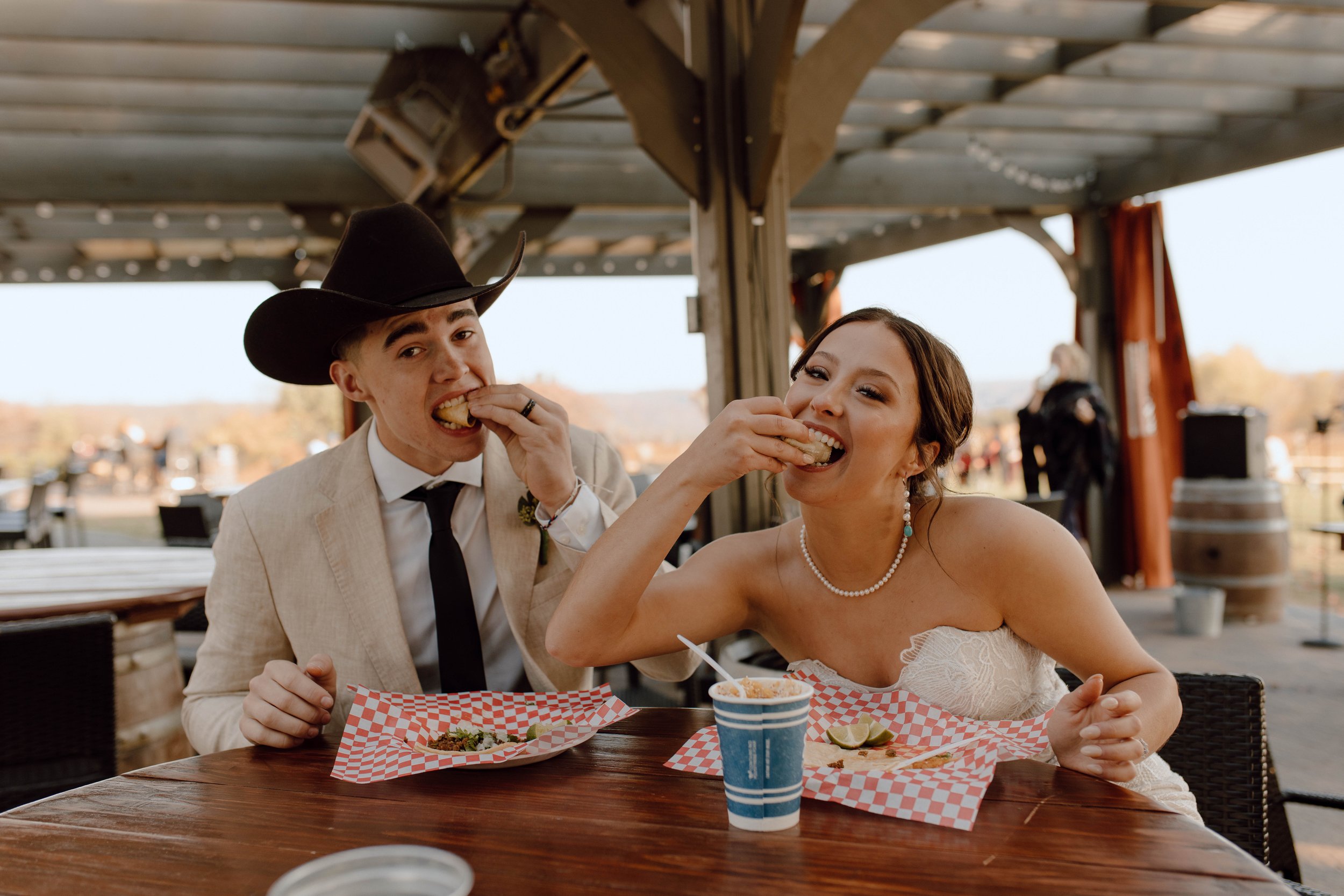 Bride and Groom eating tacos on wedding day