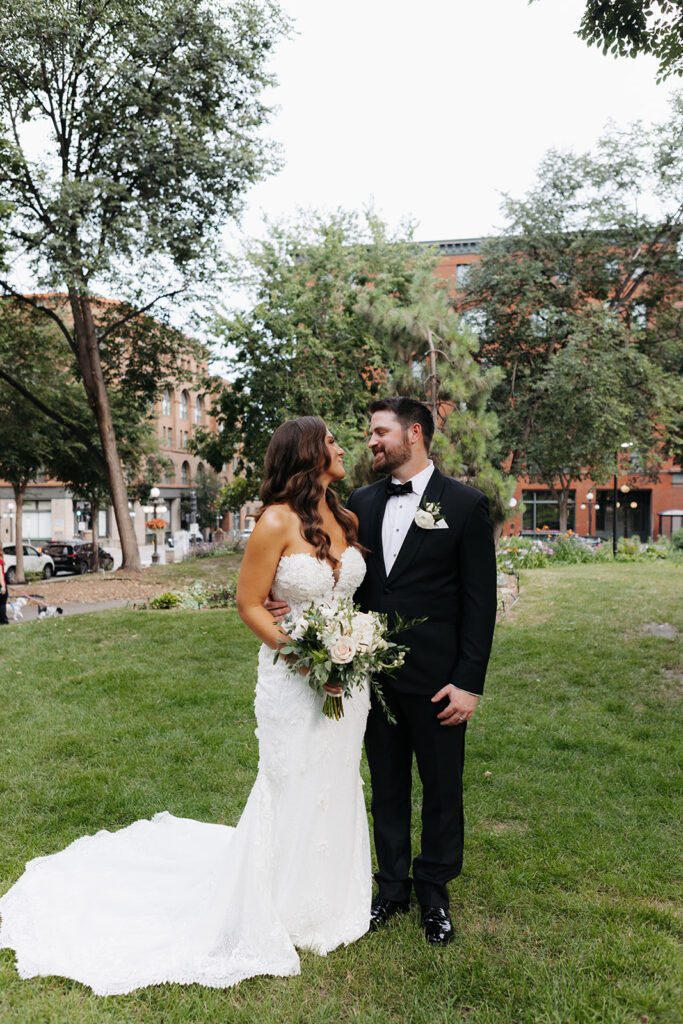 bride and groom taking photos in the city
