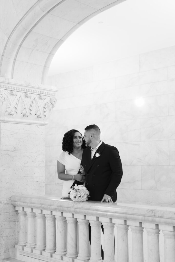 Bride and groom standing in front of marble columns at City Hall Minneapolis