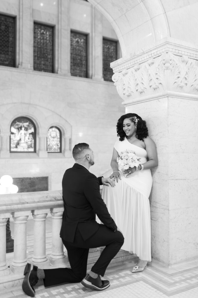 Bride and groom standing in front of marble columns at City Hall Minneapolis