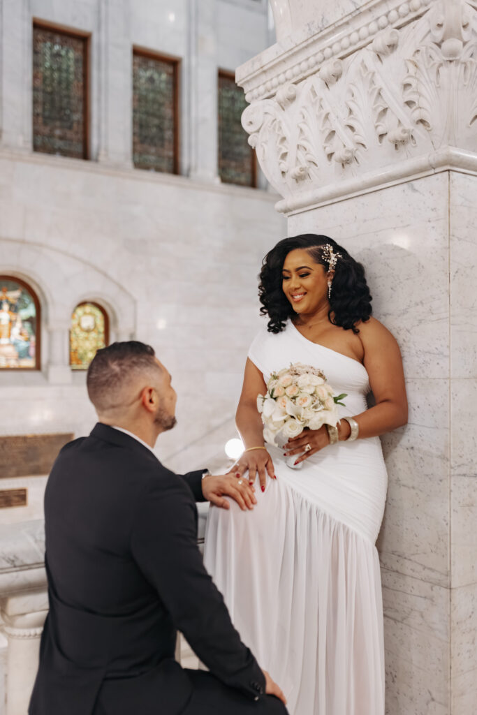 Bride and groom standing in front of marble columns at City Hall Minneapolis